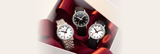 Three MONDAINE SBB watches in a gift box with red ribbon