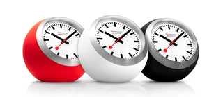 Three round clocks in red, white, and black on a white background